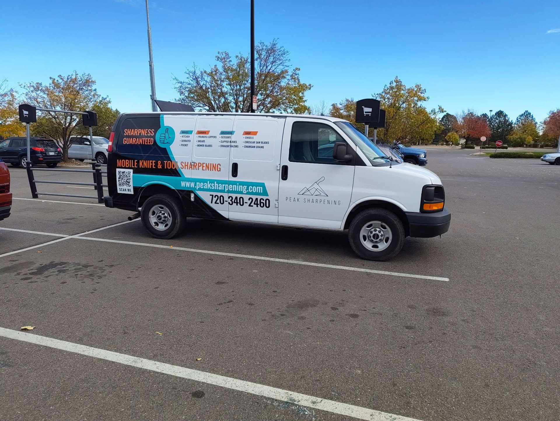 Peak Sharpening branded mobile sharpening van parked on a residential street